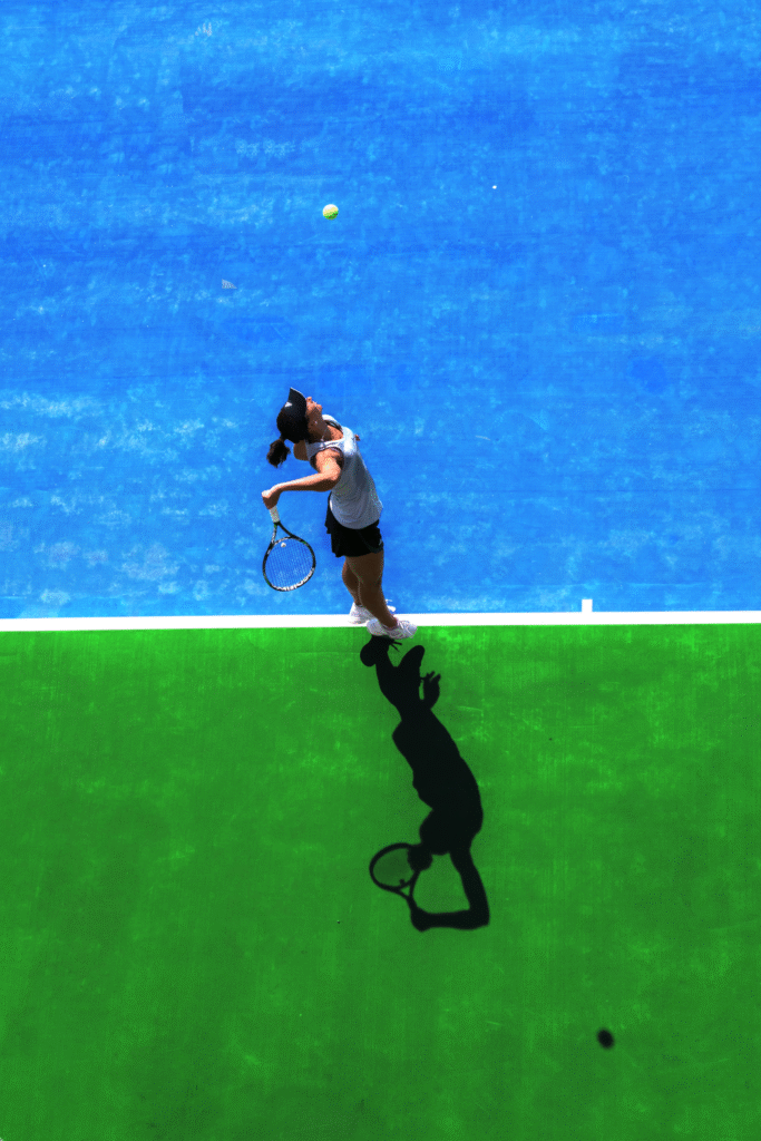 Tennis Serve by Female Player on Hard Court Tennis serve performed by a female player on a blue and green hard court